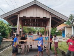 Pemdes Bersama Masyarakat Desa Lestari Gotong Royong Pindahkan Poskamling